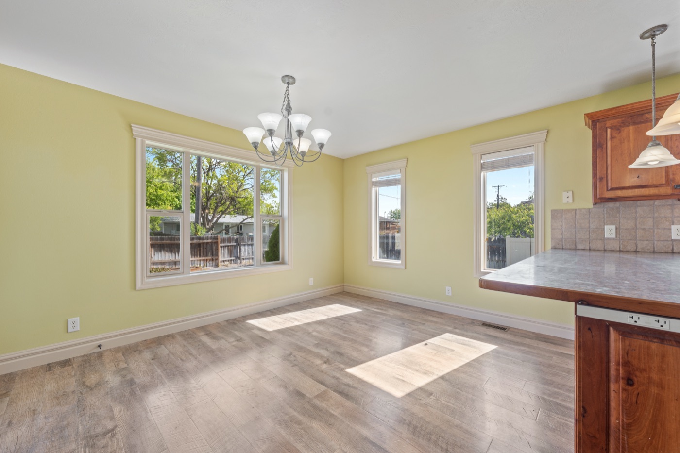 Dining nook with chandelier and large windows